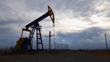 Silhouette-of-Industrial-Oil-Well-Pumpjack-Pumping-Crude-Oil