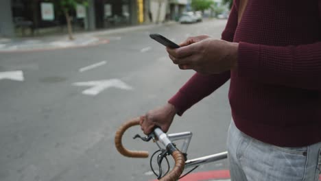 african american man using his phone in the street