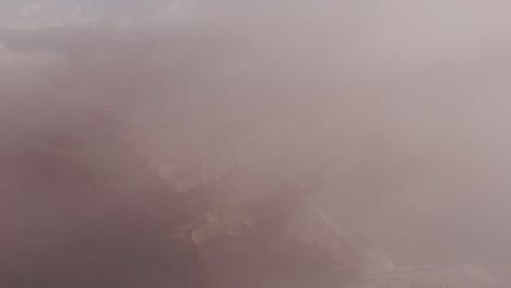 Aerial-Drone-Push-In-Clouds-Reveals-Canyon-Below-Along-Route-52