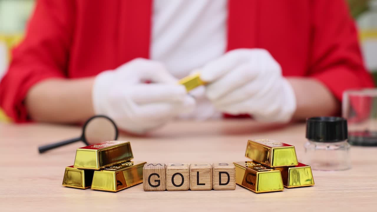 Gold bars and wooden blocks spelling "GOLD"