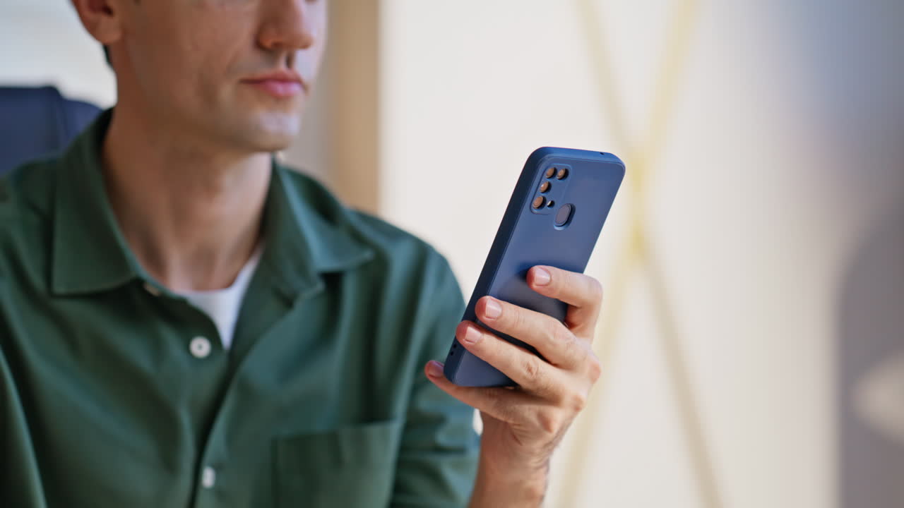 Entrepreneur looking cellphone screen reading business message at office closeup