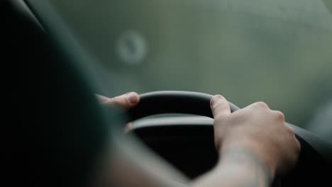 close-up of hands steering car on foggy road, safety and travel concept