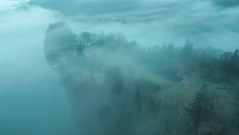 drone hovering above an island in the middle of the windermere lake in the bowness-on-windermere town, a national park loacted in furness district in cumbria, england