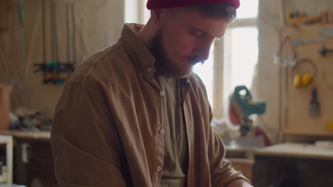 Woodworker Using Ruler and Pencil for Measuring Plank