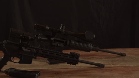 two types of ar 15 rifles standing on a wooden surface