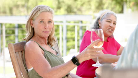 caucasian and senior biracial women enjoy a sunny outdoor setting