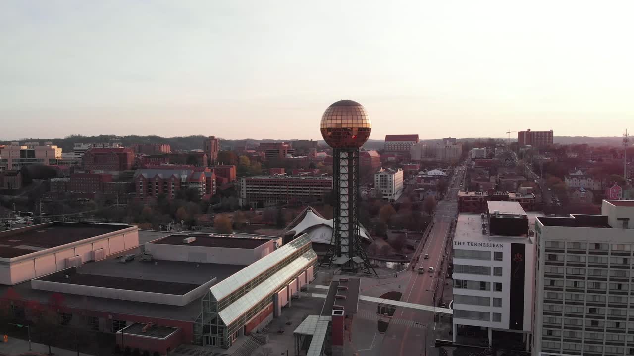 Aerial footage of Sunsphere in downtown Knoxville, Tennessee flying straight forwards over city and traffic