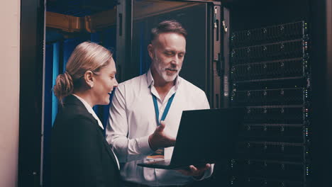 a  mature man and young woman using a laptop