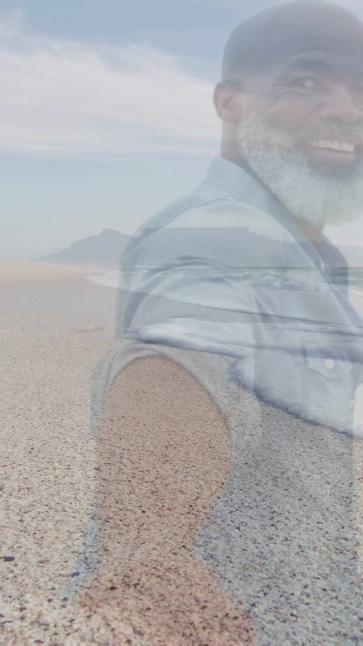 Vertical video: Man reaching camera, turning smiling and guiding for marketing, faint shore overlay