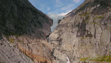 approaching briksdalsbreen glacier in norway, scandinavia with thick ice. epic mountain nature aerial.