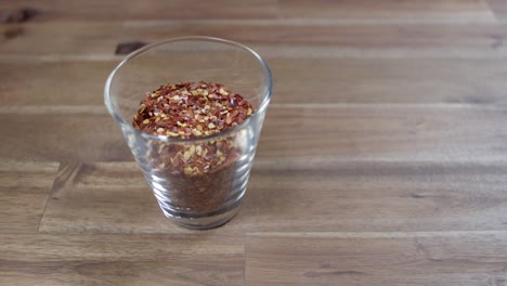 Ground-dried-chili-in-a-small-glass-container,-essential-ingredient-for-the-preparation-of-argentine-chimichurri