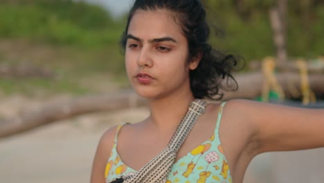 nostalgic girl on the beach enjoying the sea at sunset, slowmotion