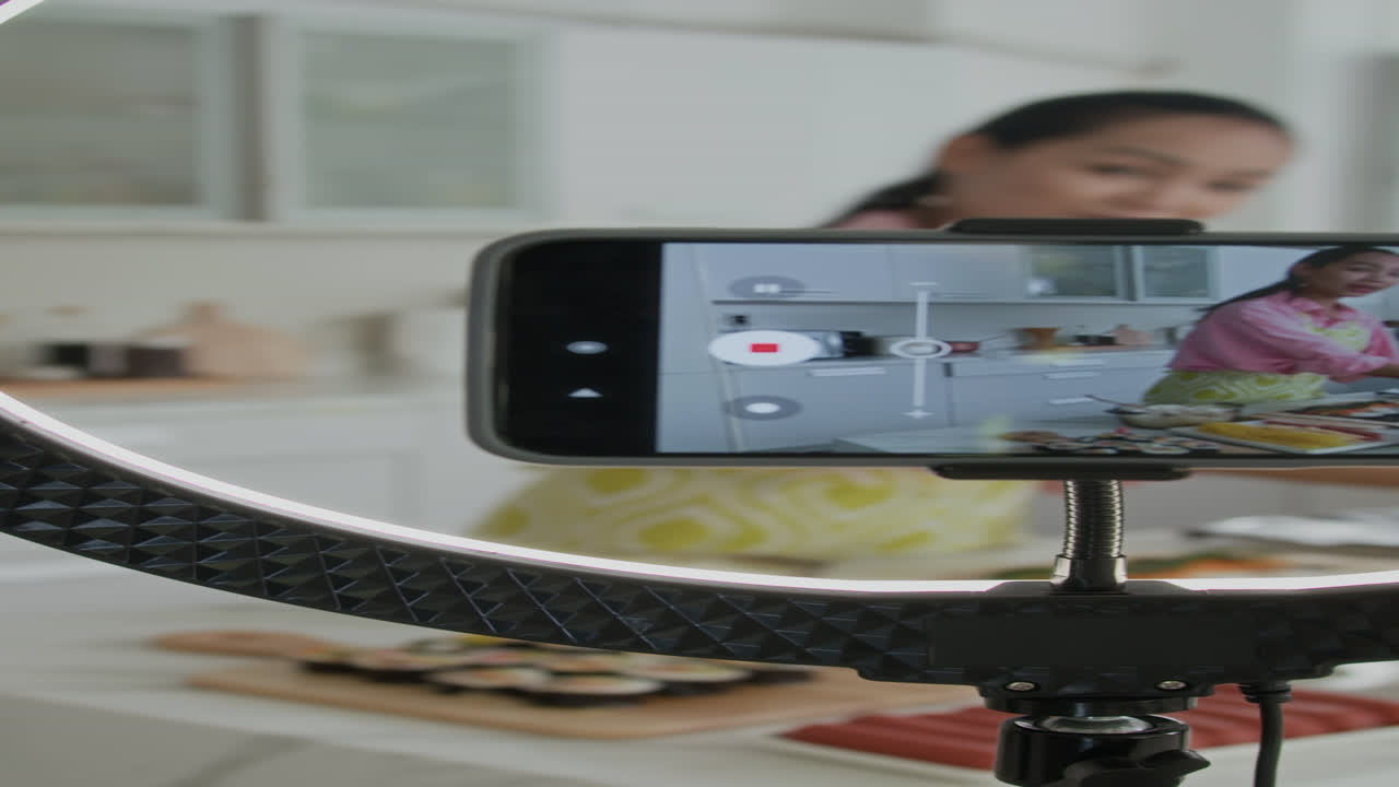 Blogger Making Video on Smartphone for Cooking Blog at Home