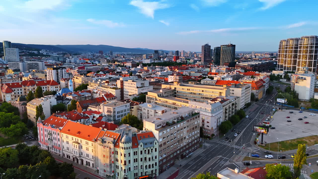 Mixture of old and new architecture in the urban landscape of Bratislava, Slovakia. Drone footage over the cityscape at sunset