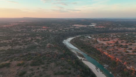 idyllic scenery of fields and llano river in texas at sunset - aerial drone shot