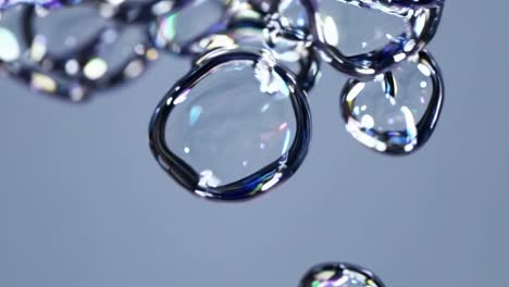 close-up video of floating water droplets on a smooth surface, captured from a top-down angle