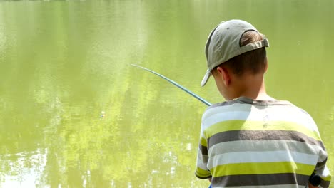 boy fishing nearby river