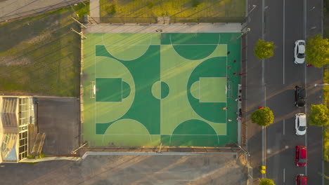 students organizing themselves at one end of basketball court