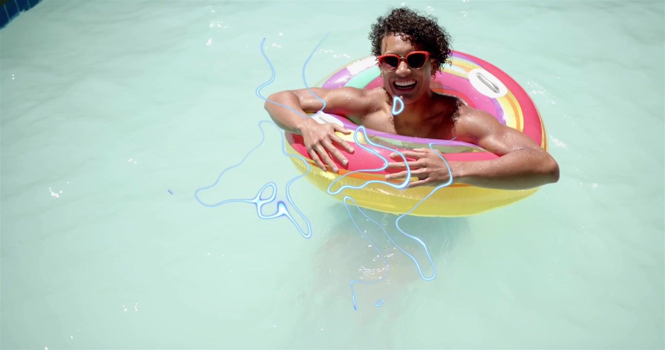 Adult man floating in turquoise pool, nudging ring and sending blue squiggles across pool for ads