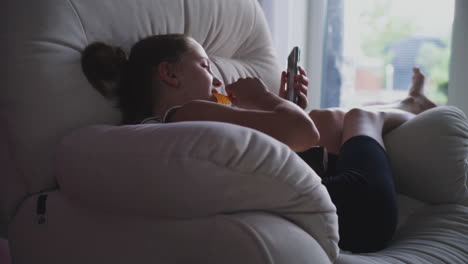 girl using smartphone on couch