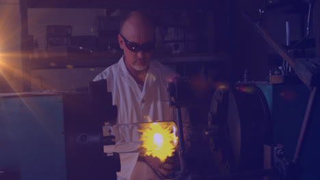 animation of glowing light over caucasian man working in workshop