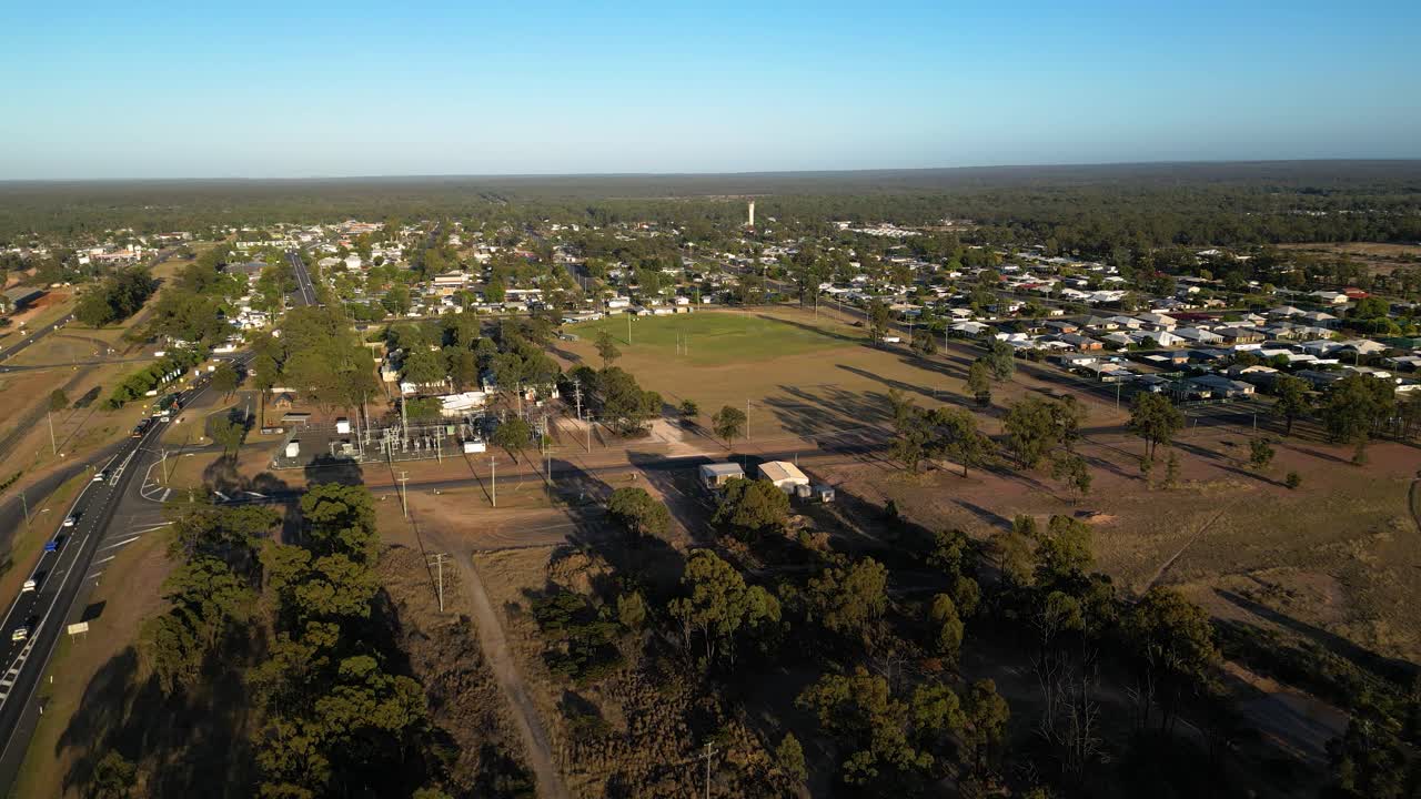 Left to right aerial views over the Warrego Highway, sporting fields and residential housing, Miles Queensland.