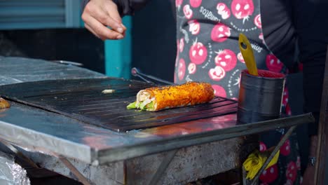 spices being sprinkled over some salty fish street food in istanbul