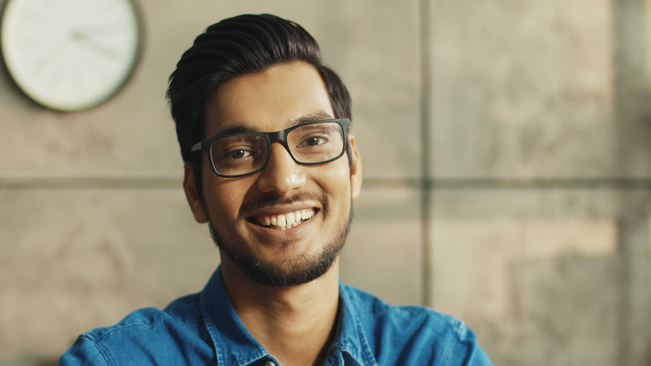 Close Up Portrait Of Joyful Office Worker With Glasses Smiling To Camera While Sitting At Table At Workplace