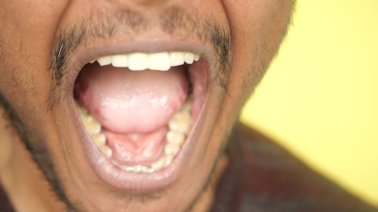 Close-up of a man's mouth, expressing various emotions