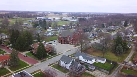 aerial view over sheridan town autumnal neighbourhood in hamilton county indiana towards methodist church