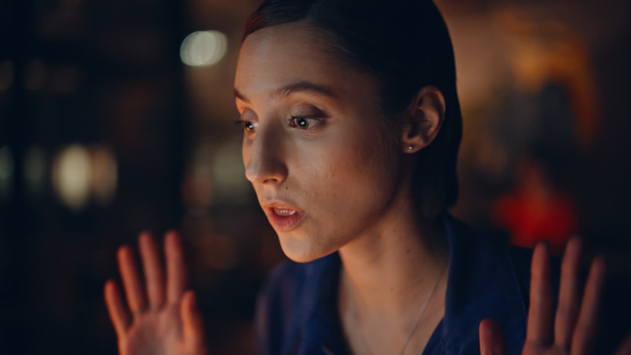 Closeup brunette video calling in night apartment. Portrait business consultant