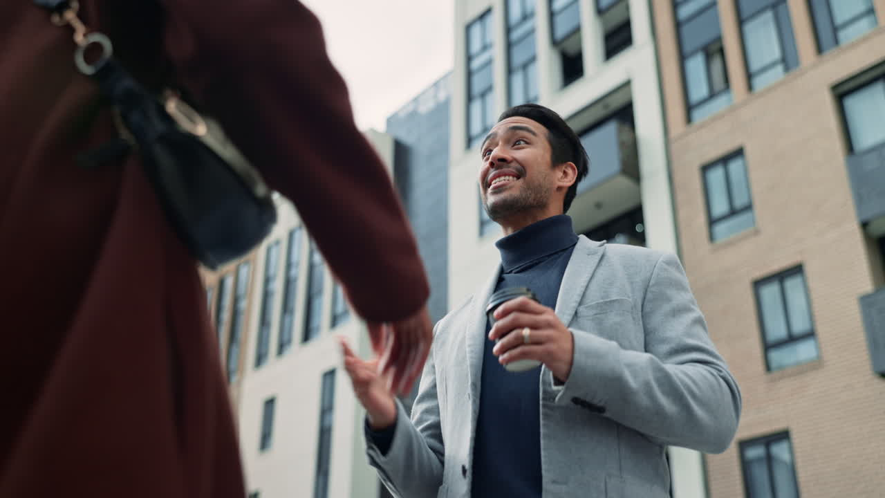 A man and a woman greet each other on the street.