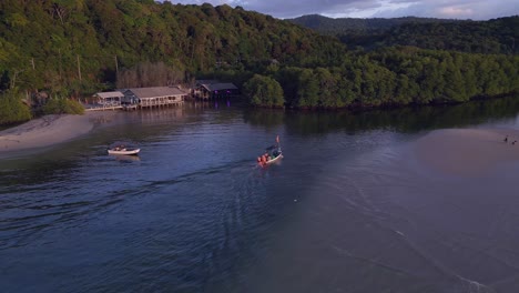 boat goes into river next to sandbar