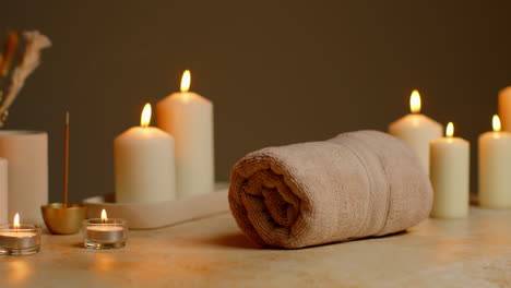 still life of lit candles with dried grasses incense stick and soft towels as part of relaxing spa day decor 5