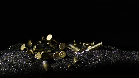 bullets with a hallmarked 'a' on the bottom piled over gunpowder