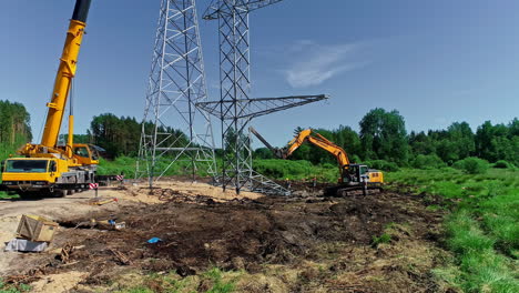 crane a crew team erecting a electrical transmission tower in the countryside