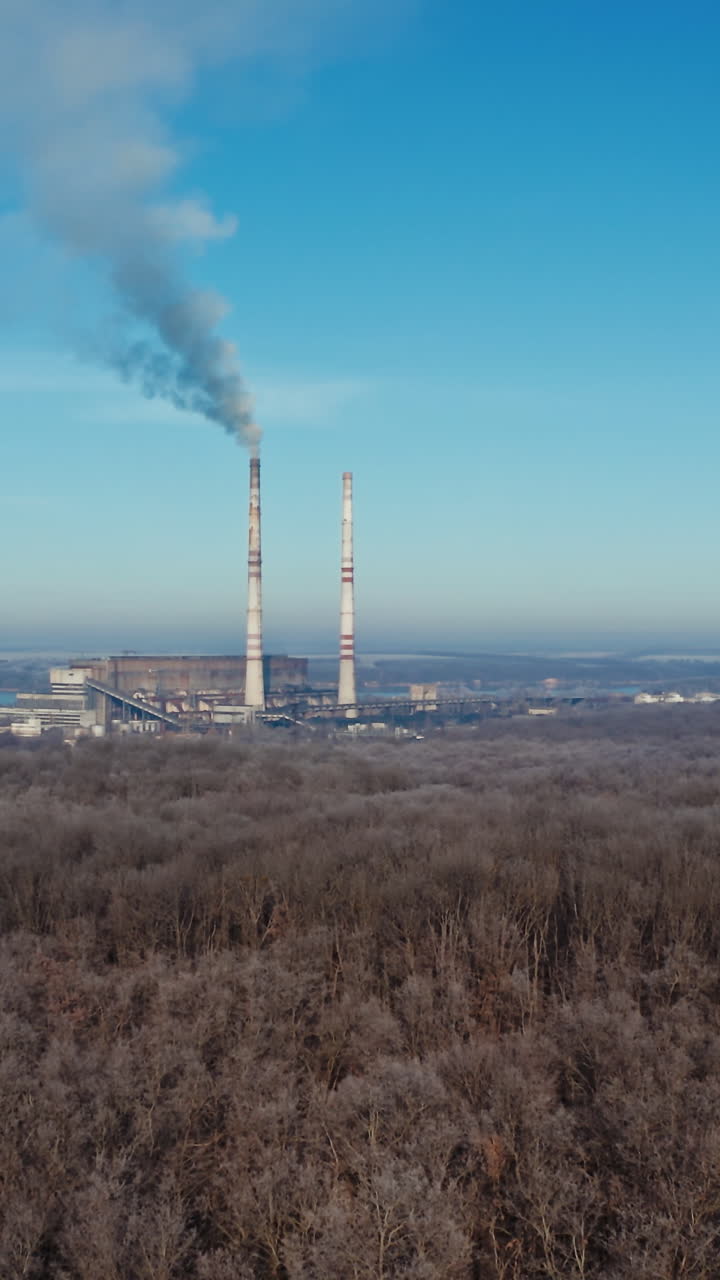 Aerial view of industrial zone. Air pollution by smoke coming out of two factory chimneys