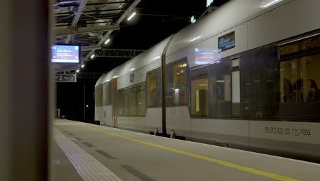 The-PKM-train-is-leaving-the-platform-at-the-Lech-Walesa-Airport-station-in-Gdansk---evening-time