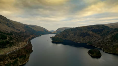 take a visual journey through the captivating cumbrian countryside, where thirlmere lake is embraced by majestic mountains in an aerial video