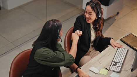 Two cheerful businesswomen working in an office