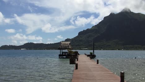 small pontoon in bora bora and view to mount otemanu, french polynesia