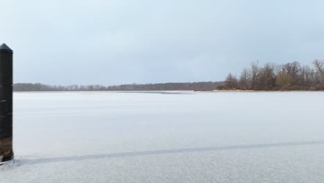 flying over a frozen bay at presque isle state park.