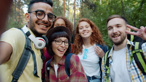 happy friends taking a selfie in the forest