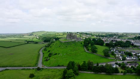 drone approaching an abandoned castle in ireland's countryside.