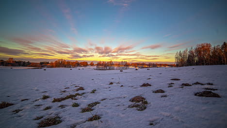 timelapse shot of white clouds passing over snow covered farmlands on a cold winter day