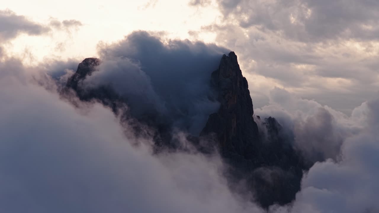 Misty peak of Cimon de la Pala, Dolomites, Italy at sunrise, serene view