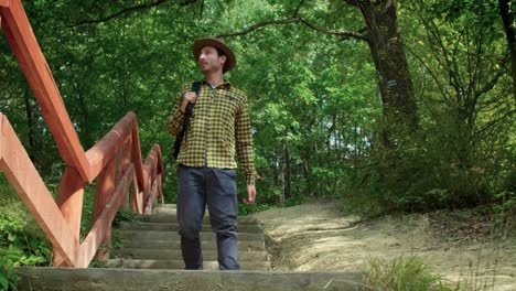 Man-with-backpack-hiking-and-looking-at-view