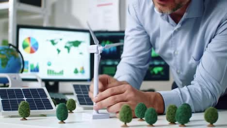 engineer adjusting wind turbine model for renewable energy project