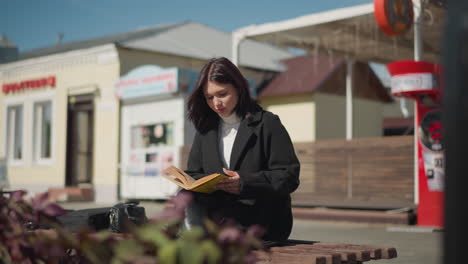 researcher sitting outdoors on a sunny day with legs crossed, flipping through pages of a book while deeply focused, flowers sway in the breeze nearby, and a background machine beeps softly