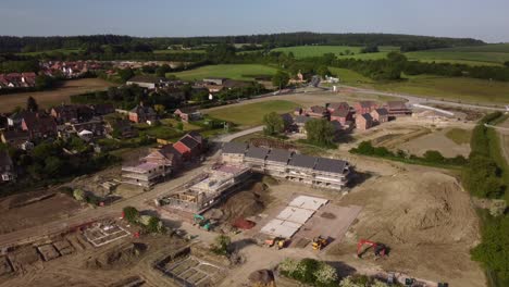 long slow drone shot orbiting countryside town with construction site